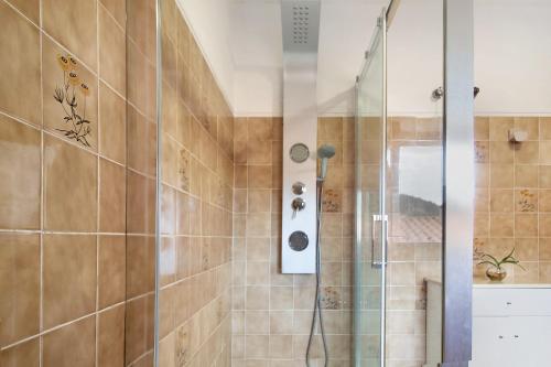 a shower with a glass door in a bathroom at Casa do Adro do Soajo in Soajo