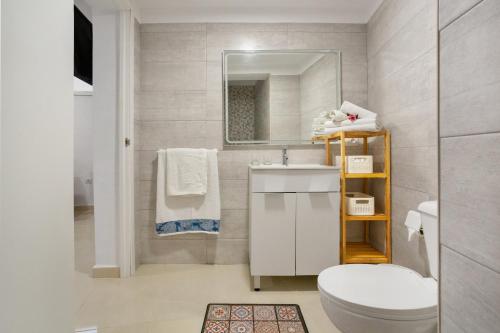 a bathroom with a toilet and a sink and a mirror at Los Abuelos 2 Icod in Icod de los Vinos