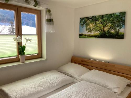 a bedroom with a bed and two windows at Urlaub bei Schönwetter in Raumberg