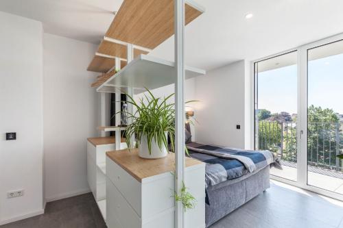 a bedroom with a bed and a large window at Modern, Cityview, Penthouse Yiwoo in Gießen