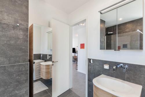 a bathroom with a sink and a mirror at Modern, Cityview, Penthouse Yiwoo in Gießen