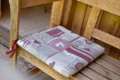 a pillow sitting on a wooden bench at Ausser Brugghof in Senales