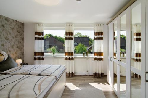 a bedroom with a bed and a large window at Ferienwohnung Goesmann in Zetel