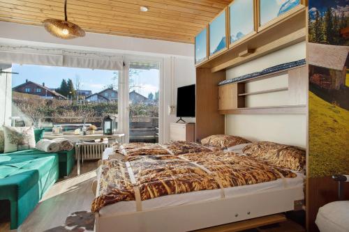 a bedroom with a large bed and a large window at Appartment Gute Zeit in Weiler-Simmerberg