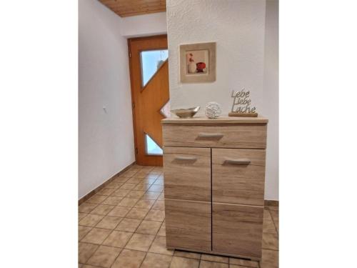 a kitchen with a wooden dresser in a hallway at Mayntz' Albjuwel in Meßstetten