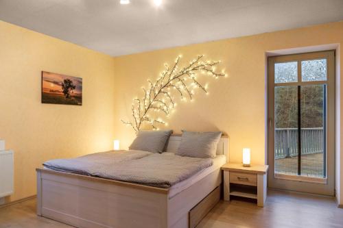 a bedroom with a bed with lights on it at Ferienwohnung 1 Hof Schäfer in Waldeck