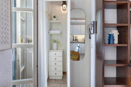a hallway with a mirror and a white dresser at Studio Apartment 1 Min From Lake in Como
