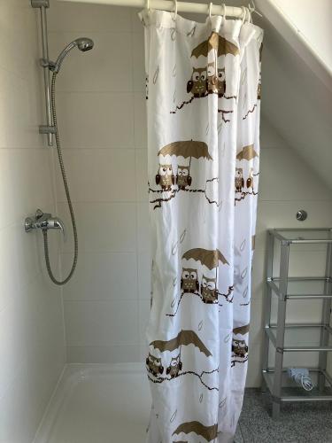 a bathroom with a shower curtain with animals on it at Kehl Vogt Ferien Apart in Warstein