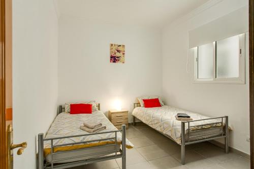 two beds sitting next to each other in a room at 2a Francesca in Vecindario