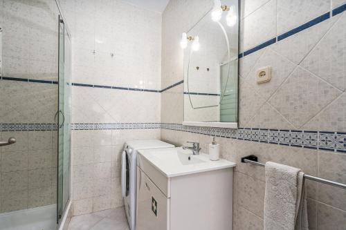 a bathroom with a sink and a shower and a mirror at Isabel apartment in Carvoeiro