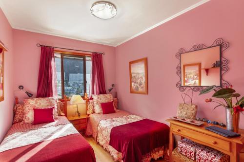 a bedroom with two beds and a mirror at Bungalow Flores with view in Puerto Rico de Gran Canaria