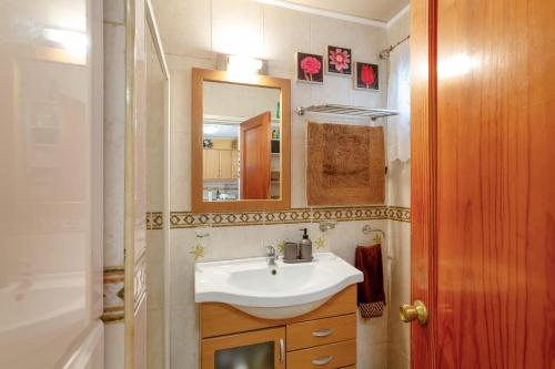 a bathroom with a sink and a mirror at Bungalow Flores with view in Puerto Rico de Gran Canaria
