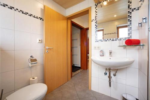 a bathroom with a sink and a toilet at Ferienhaus Hilde in Schwangau