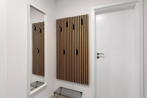 a bathroom with a mirror and a white door at Fewo Worb in Rielasingen-Worblingen