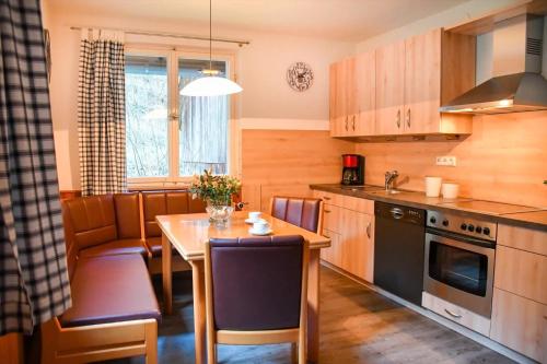 a kitchen with a table and a dining room at Rinkenbachhof in Schenkenzell