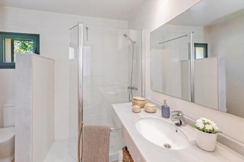 a white bathroom with a sink and a shower at Finca Sa Pradera in Palma De Mallorca
