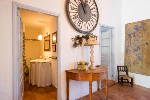 a room with a table and a clock on the wall at Baix d' Or in Felanitx
