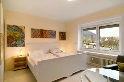 a bedroom with a bed and a large window at Haus unterm Räuschenberg in Höxter