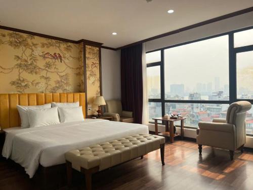a bedroom with a large bed and a large window at Hanoi Central Westlake Hotel in Hanoi