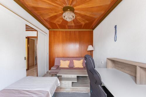 a room with two beds and a table and chairs at Calle Apolo 3 in Torrevieja