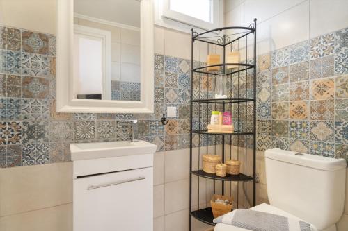 a bathroom with a toilet and a mirror at Stathis Suite in Exanthia