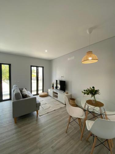 a living room with a couch and a table at Apartment T2 Olhão in Olhão