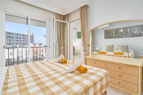 a bedroom with a large bed and a balcony at Casa Ramos Con Jacuzzi in Nerja