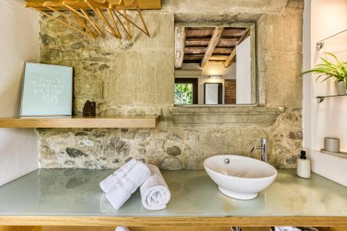 a bathroom with a sink and a bath tub at La Pallissa - Can Bonet in Sant Martí Vell