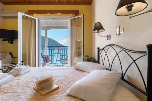 a bedroom with a bed with a view of a balcony at Apostolos Apartment 4 in Póndi