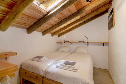 a bedroom with a bed in a room with wooden ceilings at Casa Burro in Moncarapacho
