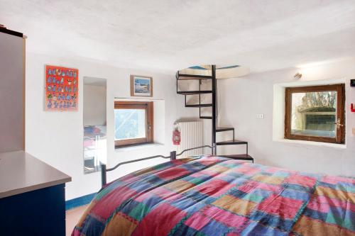 a bedroom with a colorful bed and a spiral staircase at Seroa 1 in San Bernardino