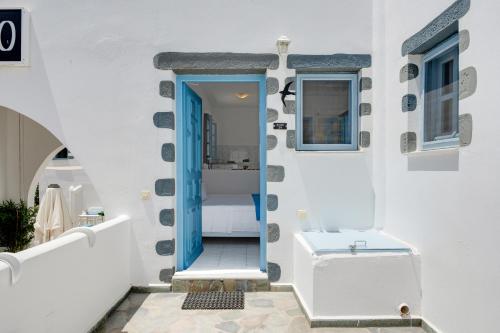 a bathroom with a blue door and a sink at Pico Bello Patmos 24 in Patmos