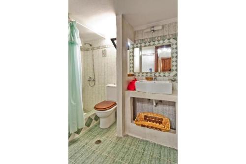 a bathroom with a toilet and a sink at Villa Ntora in Afiartis