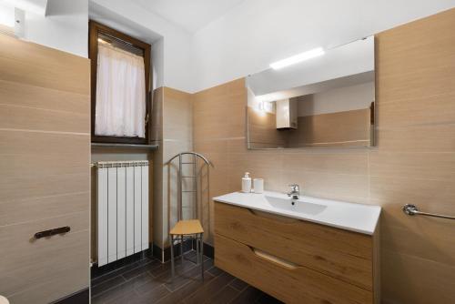 a bathroom with a sink and a mirror at La Casa Sul Lago in Osiglia