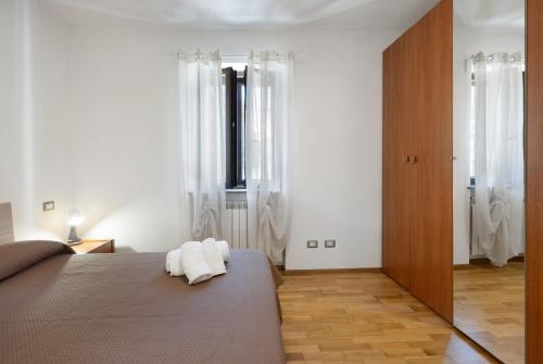 a bedroom with a bed with two towels on it at La Casa Sul Lago in Osiglia