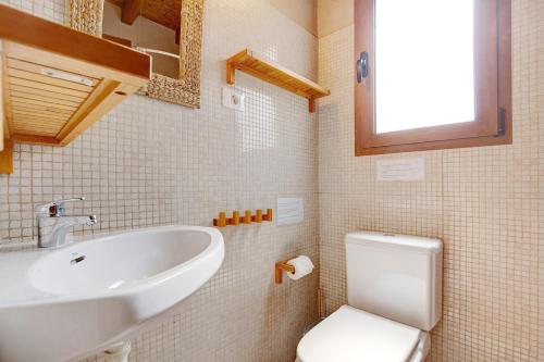 a small bathroom with a sink and a toilet at Yukalele 2 in Lajares