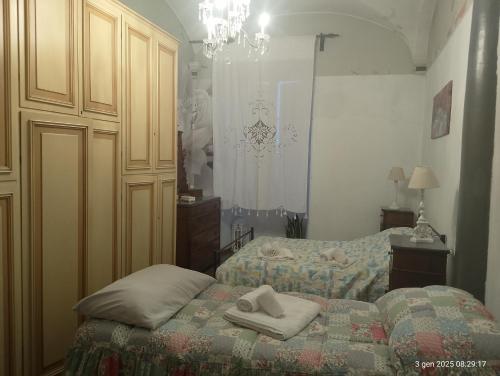 a bedroom with two beds with towels on the bed at La Vista Sul Castello in Compiano