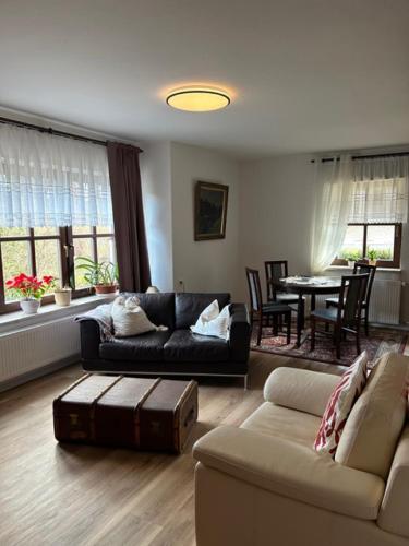 a living room with a couch and a table at Ferienhaus Waldeck in Marienberg