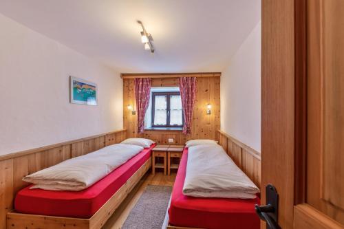 a room with two beds and a table in it at Florerhof Ferienwohnung Rose in Vols am Schlern