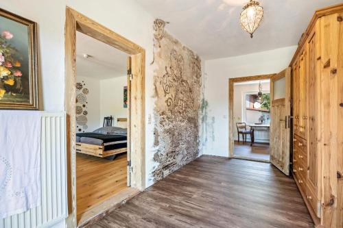 a room with a stone wall and a bedroom at Kleines Glück in Seedorf