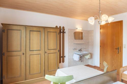 a small bathroom with a bed and a sink at Ferienwohnung Dornauer Sommer in Hippach