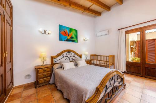a bedroom with a bed and a window at Finca Kelly in Artá