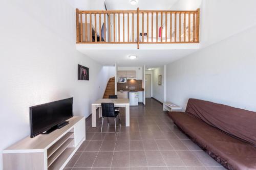 Il comprend un salon avec un lit, une télévision et une cuisine. dans l'établissement Terres de France - Le Domaine de Bacchus, à Saint-Christol