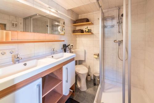a bathroom with two sinks and a shower at Chalet Zur Auszeit in Aschau