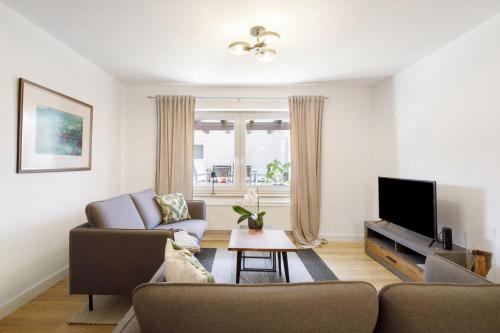 a living room with a couch and a tv at Waldmariechen in Neresheim