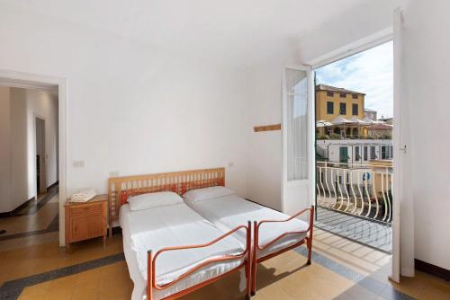 a bedroom with a bed and a balcony at Dai Baccino in Celle Ligure
