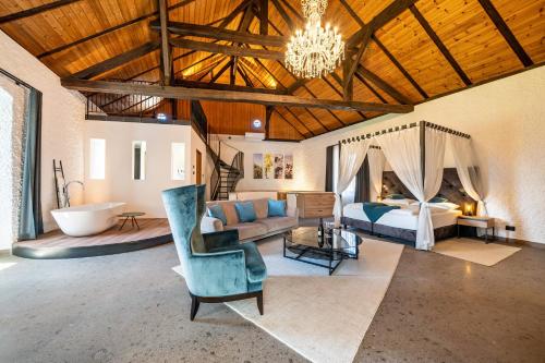 a large room with a bed and a couch and a bedroom at Thanhammer Apt Quarz in Terlano