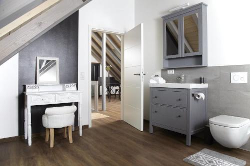 a bathroom with a sink and a toilet and a mirror at Kuckucks Hideaway in Oberibach