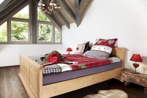 a bedroom with a bed with red and white pillows at Kuckucks Hideaway in Oberibach