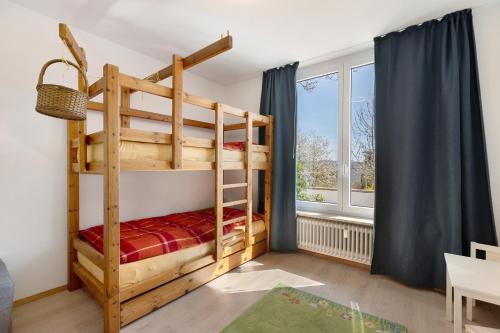 a bedroom with bunk beds and a window at Hegaudomizil in Engen